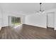 Spacious living room with hardwood floors and access to the patio at 13032 Sunrise Harvest Dr, Winter Garden, FL 34787