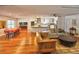 Open living room and kitchen with hardwood floors, island, and modern appliances at 2955 Lolissa Ln, Winter Park, FL 32789