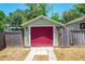 Bright red garage door with a spacious driveway at 3305 Price Ave, Orlando, FL 32806