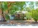 Cozy bungalow with a red door and lush landscaping at 3305 Price Ave, Orlando, FL 32806