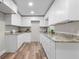 Modern kitchen with white cabinets and granite countertops at 4790 Anderson Rd, Orlando, FL 32812