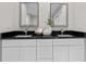 Double vanity bathroom with black granite counters at 4790 Anderson Rd, Orlando, FL 32812