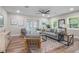 Living room with gray sofa, wood floors, and access to patio at 4790 Anderson Rd, Orlando, FL 32812