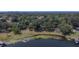 Aerial view of house on lakefront property with lush vegetation at 4790 Anderson Rd, Orlando, FL 32812