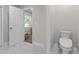 Updated bathroom featuring a toilet and marble flooring at 4790 Anderson Rd, Orlando, FL 32812