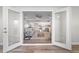 View of living room and kitchen through open French doors at 4790 Anderson Rd, Orlando, FL 32812