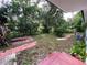 Backyard with brick pavers, lush landscaping and a wooden walkway at 2308 Lake Helen Osteen Rd, Deltona, FL 32738