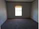 Spacious carpeted bedroom with a window and neutral walls at 45814 Lake St, Paisley, FL 32767