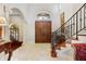 Elegant entryway with double doors and ornate staircase at 1911 Lake Markham Preserve Trl, Sanford, FL 32771
