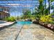Freeform pool with a waterfall and screened enclosure at 1911 Lake Markham Preserve Trl, Sanford, FL 32771