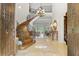 Grand entry with curved staircase, chandelier, and large doors at 1911 Lake Markham Preserve Trl, Sanford, FL 32771