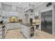 Modern kitchen with large island, granite countertops, and stainless steel appliances at 1911 Lake Markham Preserve Trl, Sanford, FL 32771