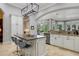 Modern kitchen with large island, granite countertops, and stainless steel appliances at 1911 Lake Markham Preserve Trl, Sanford, FL 32771