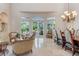 Bright dining area with large windows and a formal dining table at 1911 Lake Markham Preserve Trl, Sanford, FL 32771