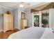 Main bedroom with hardwood floors, access to private patio and spiral staircase at 1911 Lake Markham Preserve Trl, Sanford, FL 32771