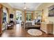 Luxurious main bedroom with a four-poster bed and sitting area at 1911 Lake Markham Preserve Trl, Sanford, FL 32771