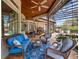 Relaxing covered patio with wicker furniture and a view of the pool at 1911 Lake Markham Preserve Trl, Sanford, FL 32771
