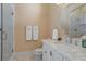 Bathroom with marble vanity, walk-in shower, and frameless glass enclosure at 1911 Lake Markham Preserve Trl, Sanford, FL 32771