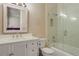 Bathroom with marble vanity, bathtub, and glass shower enclosure at 1911 Lake Markham Preserve Trl, Sanford, FL 32771
