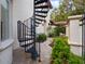 Exterior spiral staircase leading to a charming courtyard at 1911 Lake Markham Preserve Trl, Sanford, FL 32771