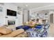 Open living room with a view into the kitchen, featuring comfortable seating and a fireplace at 1911 Lake Markham Preserve Trl, Sanford, FL 32771