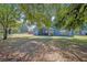 Spacious backyard with large trees and covered patio at 1112 Royal Marquis Cir, Ocoee, FL 34761