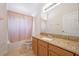 Bathroom features granite countertop, wood cabinets, and a tub at 1112 Royal Marquis Cir, Ocoee, FL 34761