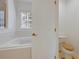 Clean bathroom with a bathtub, toilet, and access to another room at 1112 Royal Marquis Cir, Ocoee, FL 34761
