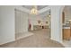 Open living room with vaulted ceiling and neutral color palette at 1112 Royal Marquis Cir, Ocoee, FL 34761