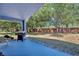 Covered patio with grill and weight bench, overlooking the backyard at 1112 Royal Marquis Cir, Ocoee, FL 34761