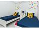 ' bedroom with twin beds, Mickey Mouse decor, and colorful walls at 4731 Clock Tower Dr # 101, Kissimmee, FL 34746