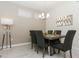 Bright dining room with a modern table and chairs, stylish light fixture, and wall art at 4731 Clock Tower Dr # 101, Kissimmee, FL 34746