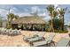 Relaxing poolside area with a thatched-roof palapa and lounge chairs at 4731 Clock Tower Dr # 101, Kissimmee, FL 34746