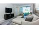 Living room with sectional sofa and large flat-screen TV at 4731 Clock Tower Dr # 101, Kissimmee, FL 34746