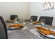Close-up view of a modern dining table set for six with elegant place settings at 4731 Clock Tower Dr # 101, Kissimmee, FL 34746