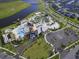 Aerial view of Storey Lake's amenities, including pool, parking and lake at 4731 Clock Tower Dr # 101, Kissimmee, FL 34746