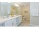 Double vanity bathroom with a large mirror and a walk-in shower at 4731 Clock Tower Dr # 101, Kissimmee, FL 34746