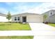 Front view of a house with a two-car garage and landscaping at 4933 Bluebell Ct, Lake Hamilton, FL 33851