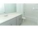 Bathroom with single vanity, bathtub, and gray cabinets at 4933 Bluebell Ct, Lake Hamilton, FL 33851