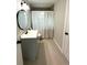 Updated bathroom with gray vanity, tile flooring, and shower at 2015 1/2 Laurel St, Bartow, FL 33830