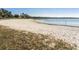 Lakefront sandy beach with grassy areas at 1088 Patriot Loop, Haines City, FL 33844