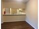 Dining room with kitchen pass-through and dark wood flooring at 670 Kenwick Cir # 204, Casselberry, FL 32707