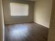 Simple bedroom with wood-look floors and a window with blinds at 670 Kenwick Cir # 204, Casselberry, FL 32707