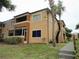 Two-story condo building with screened patio and lush landscaping at 670 Kenwick Cir # 204, Casselberry, FL 32707