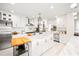 Modern kitchen with white cabinets, marble island, and stainless steel appliances at 1305 W Lake Mary Blvd, Lake Mary, FL 32746