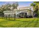 Home's backyard features a patio, grill, and a fence at 1305 W Lake Mary Blvd, Lake Mary, FL 32746