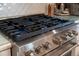Close-up of gas cooktop with lit burners at 1305 W Lake Mary Blvd, Lake Mary, FL 32746