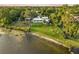 Aerial view of waterfront home with expansive lawn and lush landscaping at 1305 W Lake Mary Blvd, Lake Mary, FL 32746