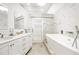 Elegant bathroom with double vanity, soaking tub and marble tile at 1305 W Lake Mary Blvd, Lake Mary, FL 32746