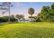 House with large backyard, palm trees, and beautiful sunset at 1305 W Lake Mary Blvd, Lake Mary, FL 32746